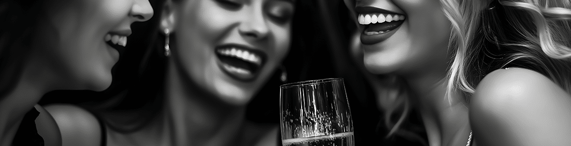 woman laughing with a glass of champagne